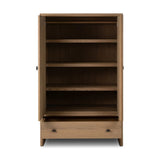 Crafted from sandy solid oak in a waterfall silhouette, this armoire adds a touch of contemporary simplicity to your bedroom. Double doors open to spacious shelving, complemented by a bottom drawer for extra storage. The piece’s bullnose edge and oval iron hardware add variety. Amethyst Home provides interior design, new home construction design consulting, vintage area rugs, and lighting in the Nashville metro area.
