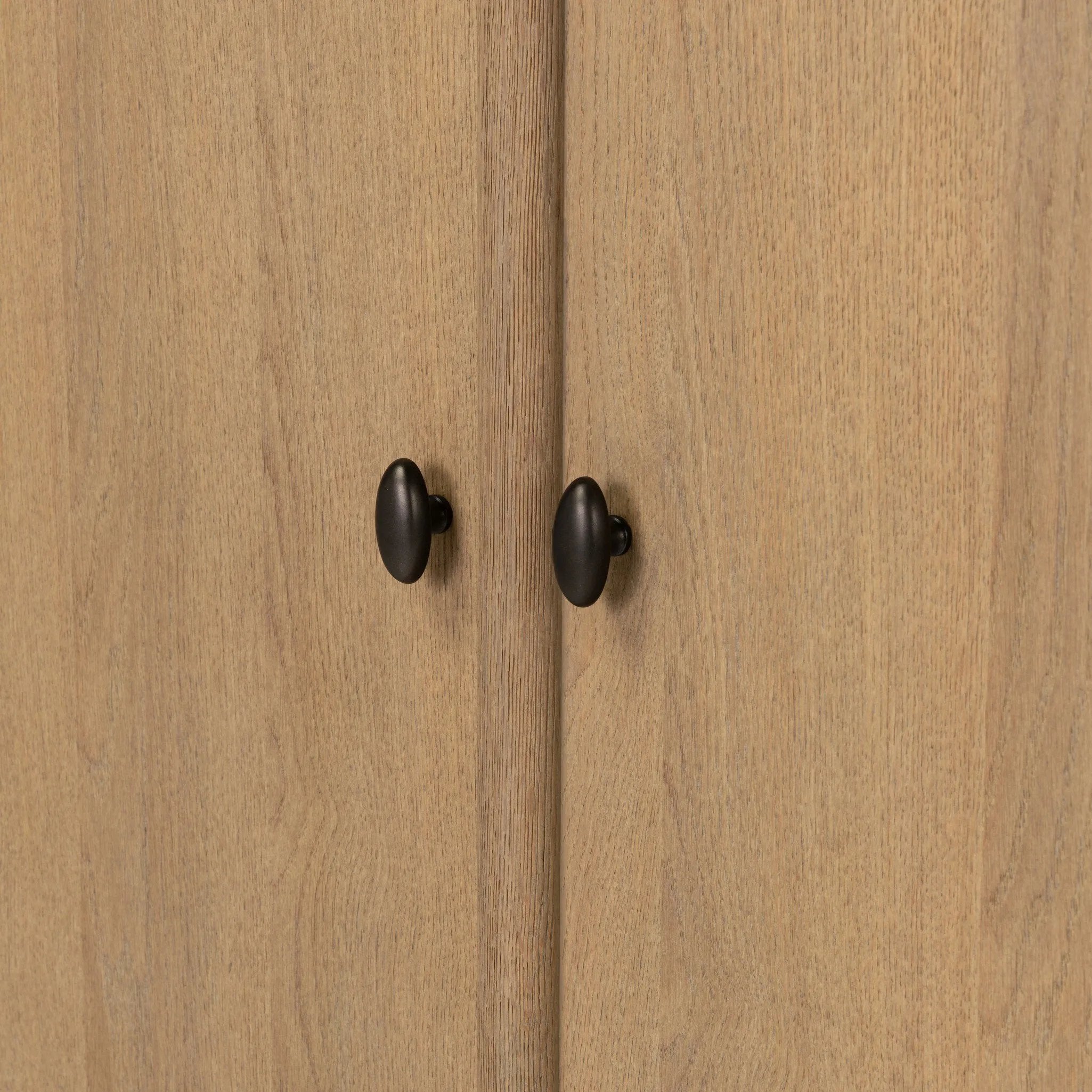 Crafted from sandy solid oak in a waterfall silhouette, this armoire adds a touch of contemporary simplicity to your bedroom. Double doors open to spacious shelving, complemented by a bottom drawer for extra storage. The piece’s bullnose edge and oval iron hardware add variety. Amethyst Home provides interior design, new home construction design consulting, vintage area rugs, and lighting in the Seattle metro area.