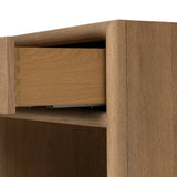Crafted from sandy solid oak in a waterfall silhouette, this nightstand adds a touch of contemporary simplicity to the bedside. Stack your favorite books on a spacious bottom shelf. The piece’s bullnose edge and oval iron drawer pull add variety. Amethyst Home provides interior design, new home construction design consulting, vintage area rugs, and lighting in the Charlotte metro area.