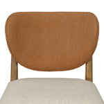 Midcentury meets organic modernism in this mixed-material dining chair. A top-grain leather seat back pairs with a cushioned seat upholstered in performance fabric, with stitch detailing along the seat back. All framed by solid oak finished in a warm amber. Amethyst Home provides interior design, new home construction design consulting, vintage area rugs, and lighting in the Calabasas metro area.