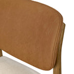 Midcentury meets organic modernism in this mixed-material dining chair. A top-grain leather seat back pairs with a cushioned seat upholstered in performance fabric, with stitch detailing along the seat back. All framed by solid oak finished in a warm amber. Amethyst Home provides interior design, new home construction design consulting, vintage area rugs, and lighting in the Newport Beach metro area.