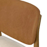 Midcentury meets organic modernism in this mixed-material dining chair. A top-grain leather seat back pairs with a cushioned seat upholstered in performance fabric, with stitch detailing along the seat back. All framed by solid oak finished in a warm amber. Amethyst Home provides interior design, new home construction design consulting, vintage area rugs, and lighting in the Newport Beach metro area.