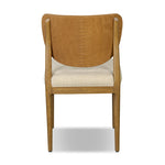Midcentury meets organic modernism in this mixed-material dining chair. A top-grain leather seat back pairs with a cushioned seat upholstered in performance fabric, with stitch detailing along the seat back. All framed by solid oak finished in a warm amber. Amethyst Home provides interior design, new home construction design consulting, vintage area rugs, and lighting in the Salt Lake City metro area.