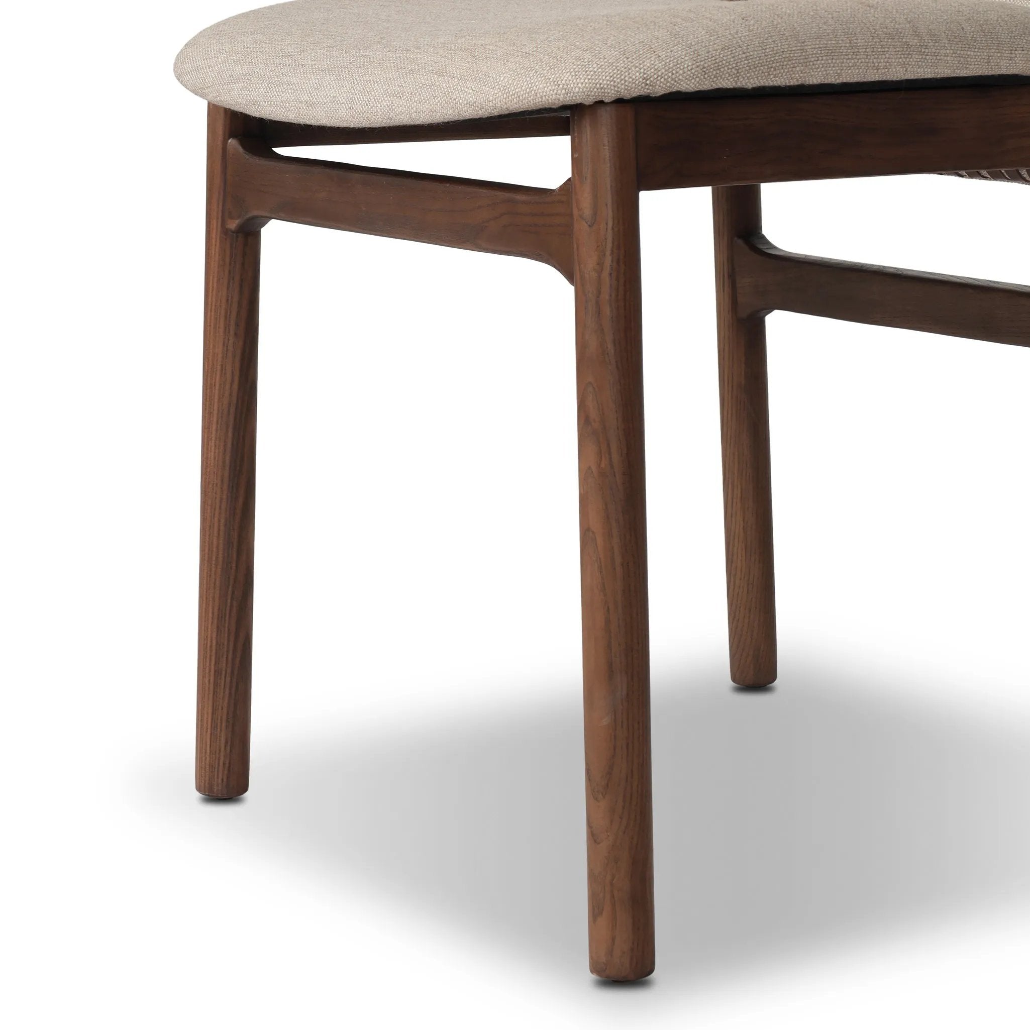 Midcentury-inspired with its minimalist wooden frame, this armless dining chair features a low back and float-like upholstered seat Amethyst Home provides interior design, new home construction design consulting, vintage area rugs, and lighting in the Houston metro area.
