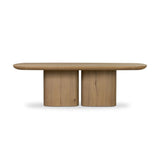 A stately dining style inspired by soft Brutalism. Crafted from aged smoked oak, a pair of matching pedestal bases features a delicate break between them, bringing a touch of lightness to such a substantial piece. A wide rectangular tabletop shapes arched sides that flow into rounded corners, finished off with bullnose edging Amethyst Home provides interior design, new home construction design consulting, vintage area rugs, and lighting in the Washington metro area.