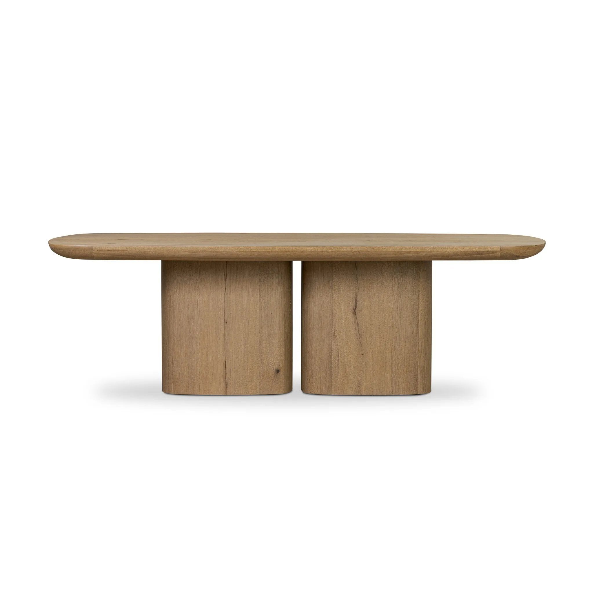 A stately dining style inspired by soft Brutalism. Crafted from aged smoked oak, a pair of matching pedestal bases features a delicate break between them, bringing a touch of lightness to such a substantial piece. A wide rectangular tabletop shapes arched sides that flow into rounded corners, finished off with bullnose edging Amethyst Home provides interior design, new home construction design consulting, vintage area rugs, and lighting in the Washington metro area.