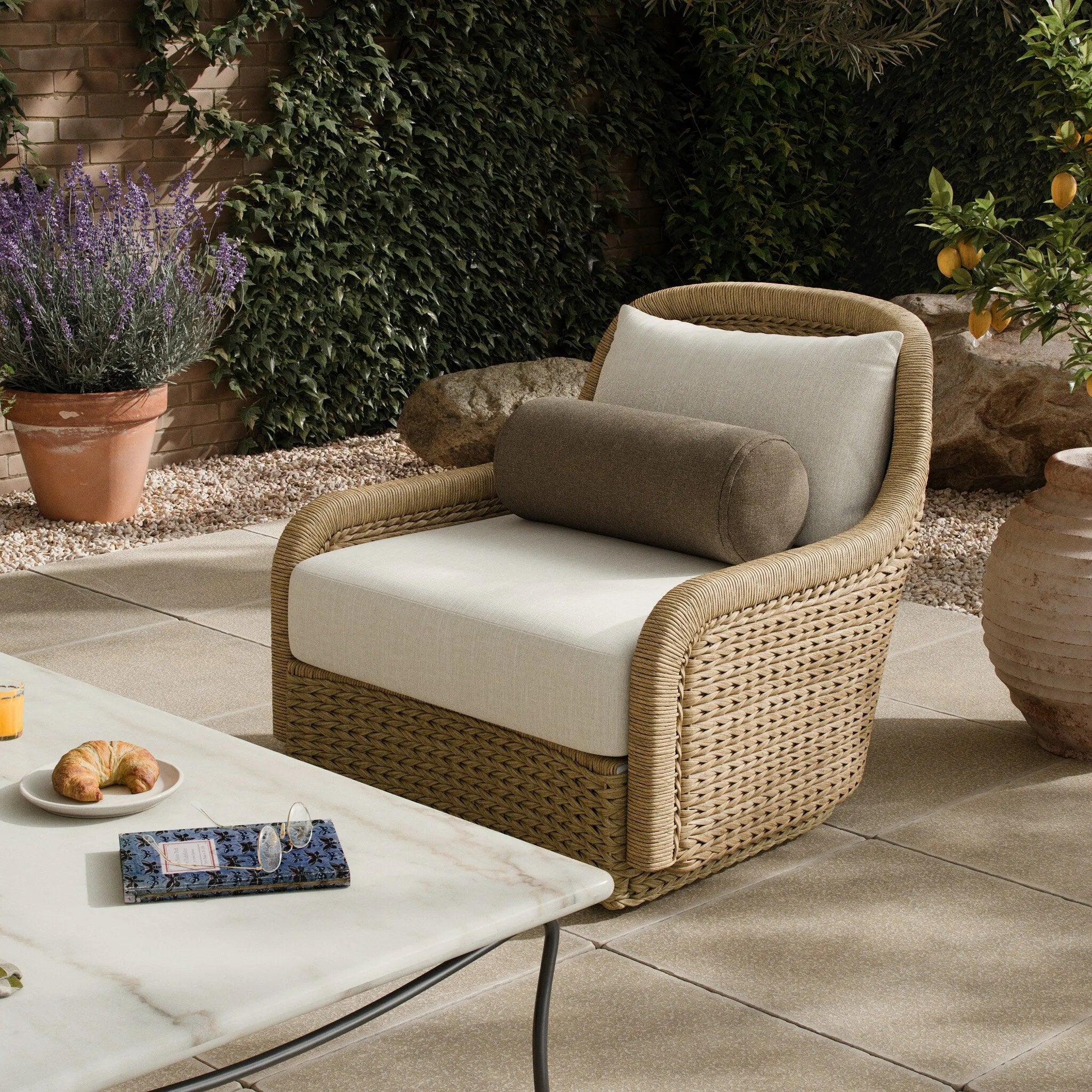 For a casual, coastal vibe, this outdoor chair takes on the classic slipper silhouette with added dimension and movement atop a 360-swivel base. It's all about the heavy braided weave technique: Faux banana leaf comes together in a mix of weave formats for added visual interest, finishing with a cord wrap detail on the arms. Amethyst Home provides interior design, new home construction design consulting, vintage area rugs, and lighting in the Winter Garden metro area.
