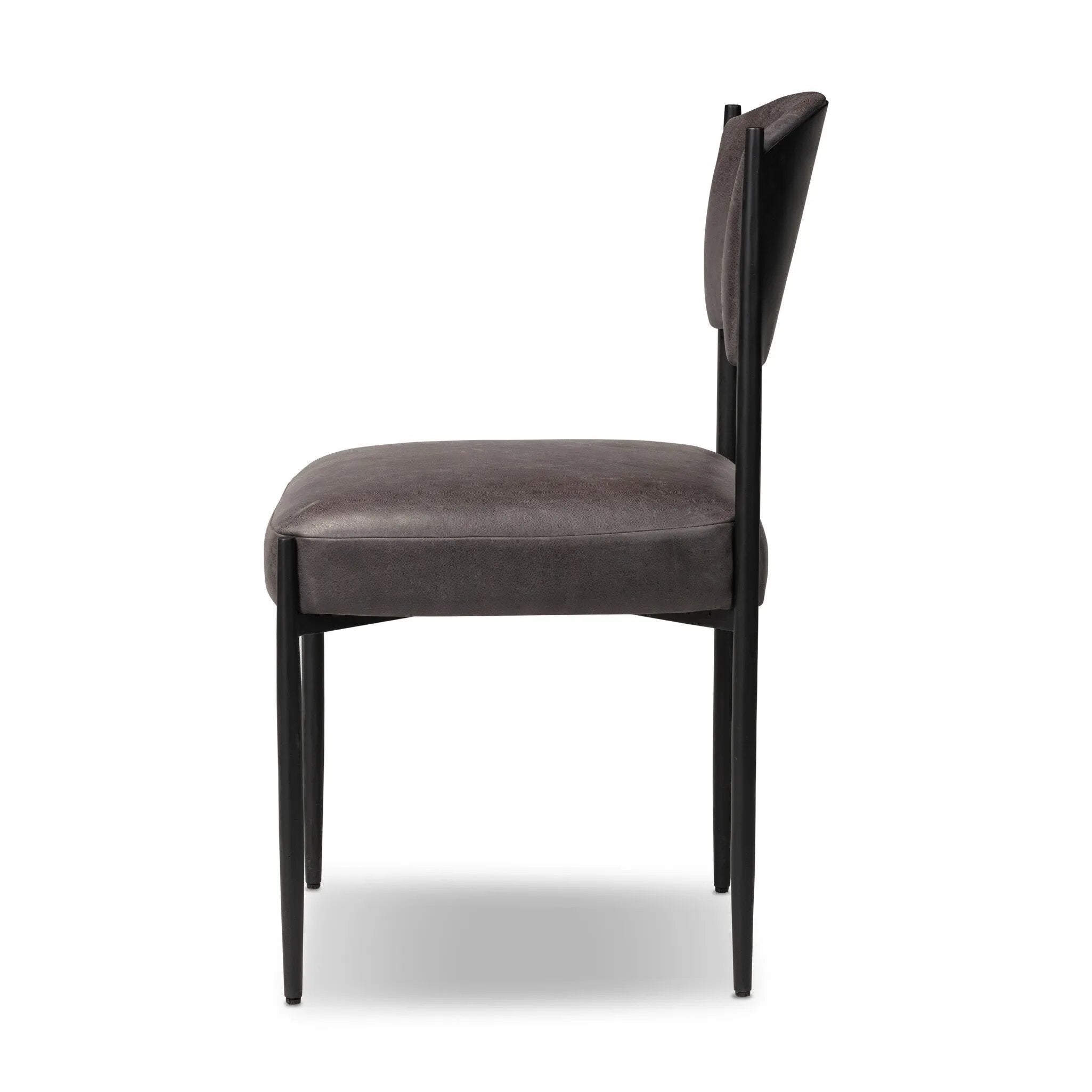 Bring a refreshed midcentury look to your table. Comfortable seat and back cushions are upholstered in a black top-grain leather, with a slim iron frame curving at the top to soften things up. Simple tapered legs complete the look.As enthusiasts of natural aesthetics at Amethyst, we love the nature inspired Bellaire Dining Chair - Palermo Black. Amethyst Home provides interior design, new home construction design consulting, vintage area rugs, and lighting in the Salt Lake City metro area.