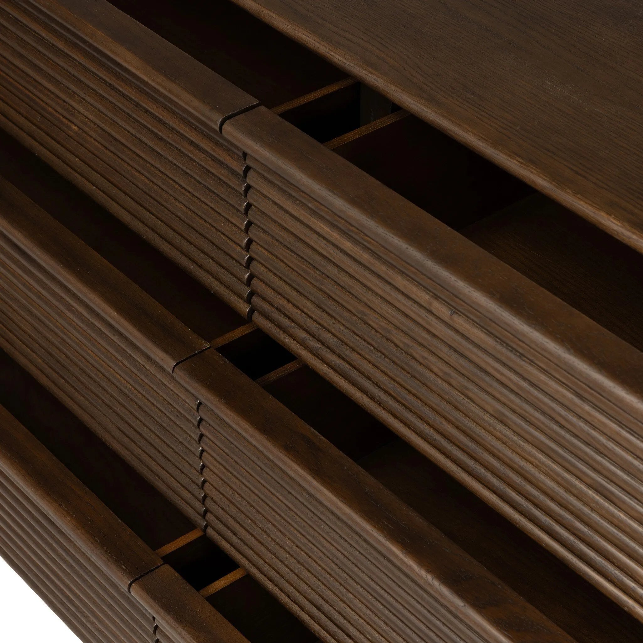 Inspired by aerodynamic-inspired Streamline Moderne style, stacked scalloped reeding wraps this spiced oak dresser with six spacious drawers. The result: a beautifully rhythmic, repeated look. With integrated hardware for a clean finish.As fans of natural materials at Amethyst, we love the nature inspired Benny 6 Drawer Dresser - Spiced Oak Veneer. Amethyst Home provides interior design, new home construction design consulting, vintage area rugs, and lighting in the Charlotte metro area.