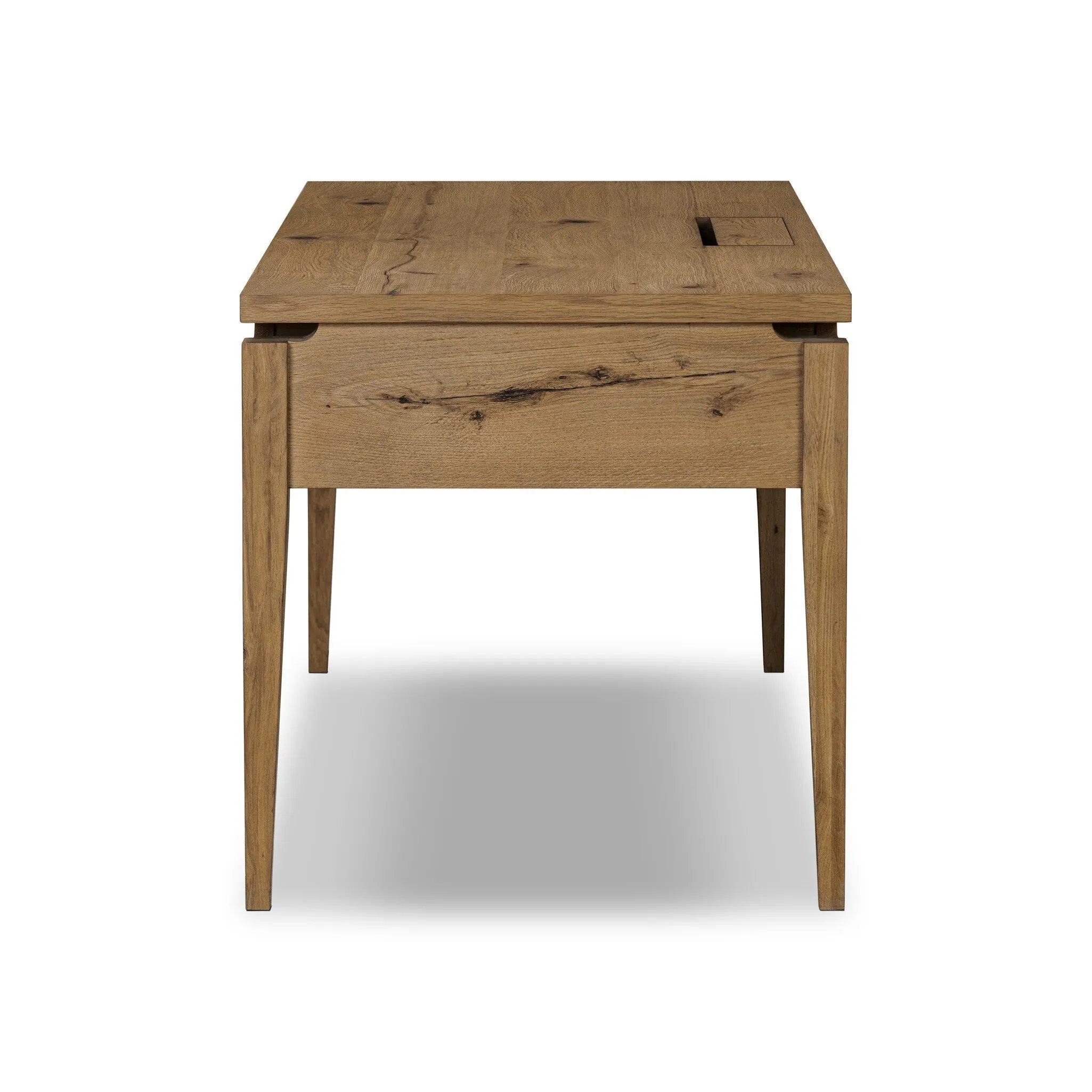 Featuring Bergstrom Warm Natural Oak Veneer Desk by Four Hands at Amethyst Home. Warm up your workspace with this light-finished writing desk of rich character oak. Tapered legs and subtle corner relief details create a simplified look that complements a home office or flex space. Complete with thoughtful touches like built-in cord management, a flip-top outlet. Amethyst Home provides interior design, new home construction design consulting, vintage area rugs, and lighting in the Tampa metro area.