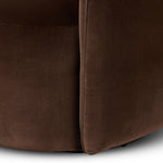 Compact and cozy, this high-back swivel chair with pillow-formed arms features contrast piping outlining its silhouette. Velvety performance fabric in a deep brown hue offers maximum comfort. The base is affixed to a 360-degree swivel for relaxed lounging. Amethyst Home provides interior design, new home construction design consulting, vintage area rugs, and lighting in the Houston metro area.