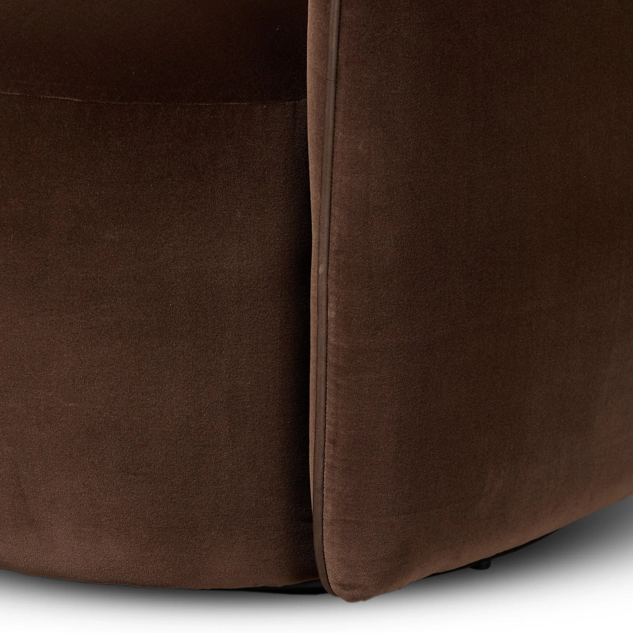Compact and cozy, this high-back swivel chair with pillow-formed arms features contrast piping outlining its silhouette. Velvety performance fabric in a deep brown hue offers maximum comfort. The base is affixed to a 360-degree swivel for relaxed lounging. Amethyst Home provides interior design, new home construction design consulting, vintage area rugs, and lighting in the Houston metro area.
