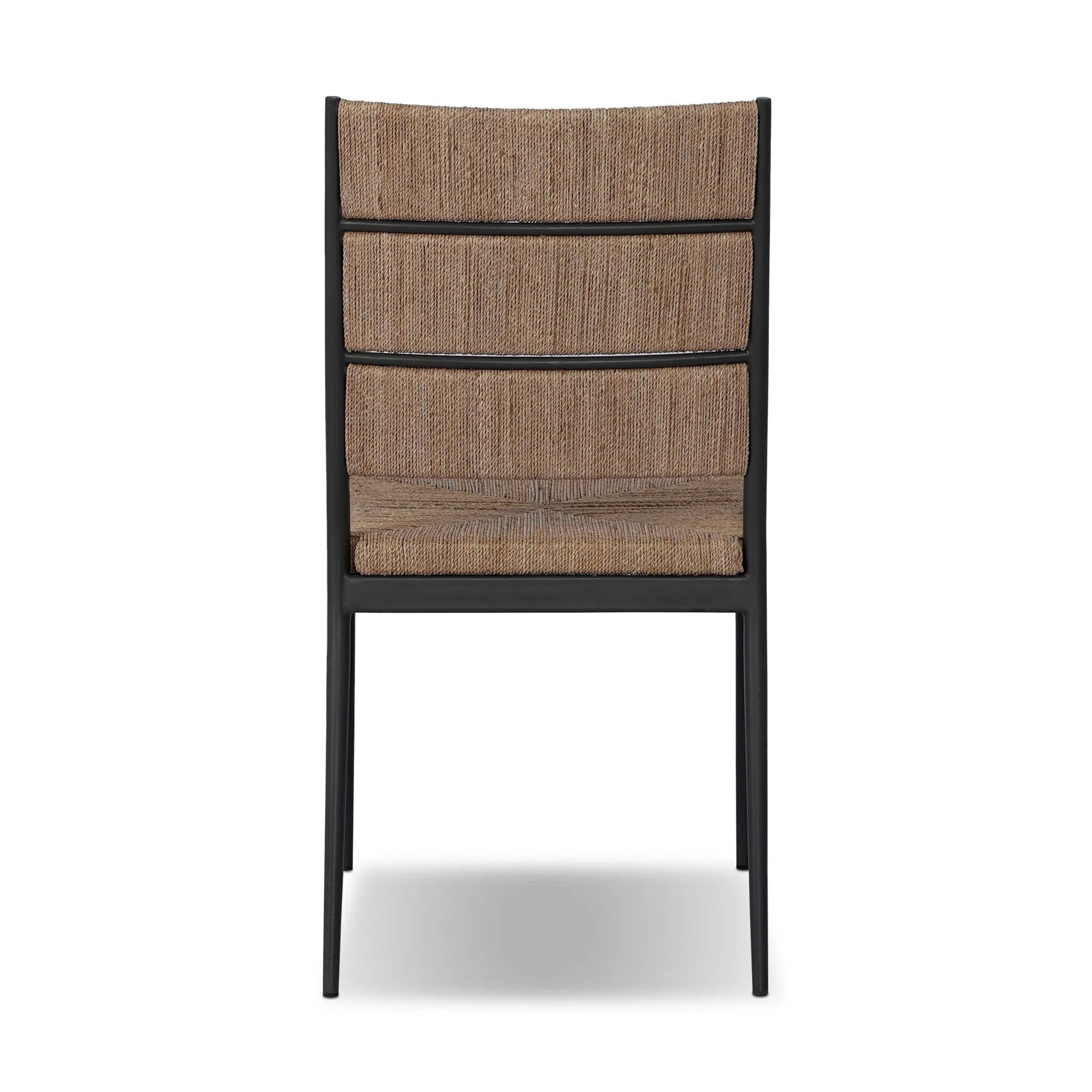 A steel dining chair frame is softened and paired with natural woven fibers. Thin, tapered legs and a tall channeled back cre