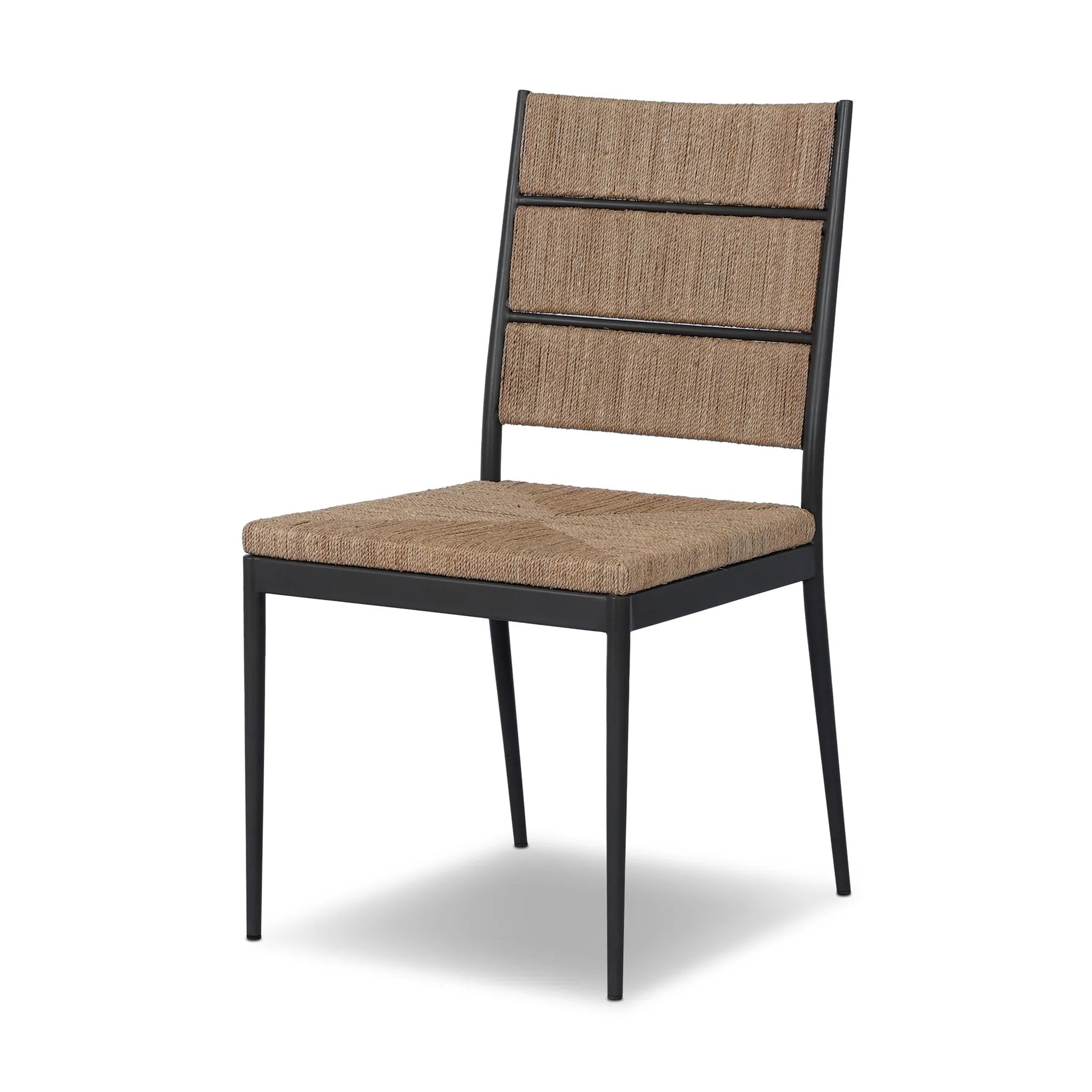 A steel dining chair frame is softened and paired with natural woven fibers. Thin, tapered legs and a tall channeled back cre