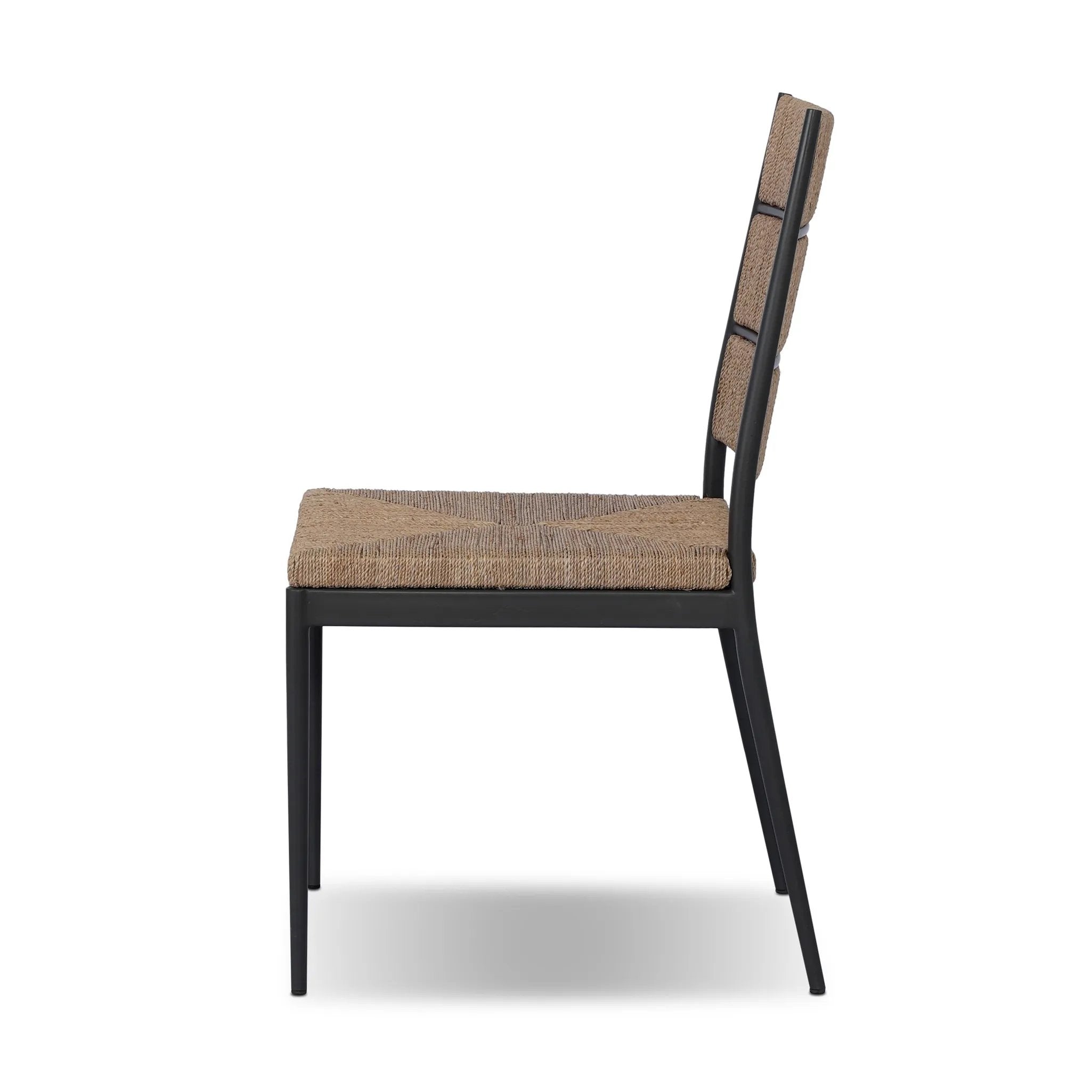 A steel dining chair frame is softened and paired with natural woven fibers. Thin, tapered legs and a tall channeled back cre
