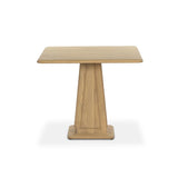 A squared shape and smaller scale makes this bistro-style table perfect for intimate spaces. Made from solid oak with a beautifully light finish, a tapered base and softened bullnose edges reflect a traditional look that works into any space with ease. Amethyst Home provides interior design, new home construction design consulting, vintage area rugs, and lighting in the Salt Lake City metro area.