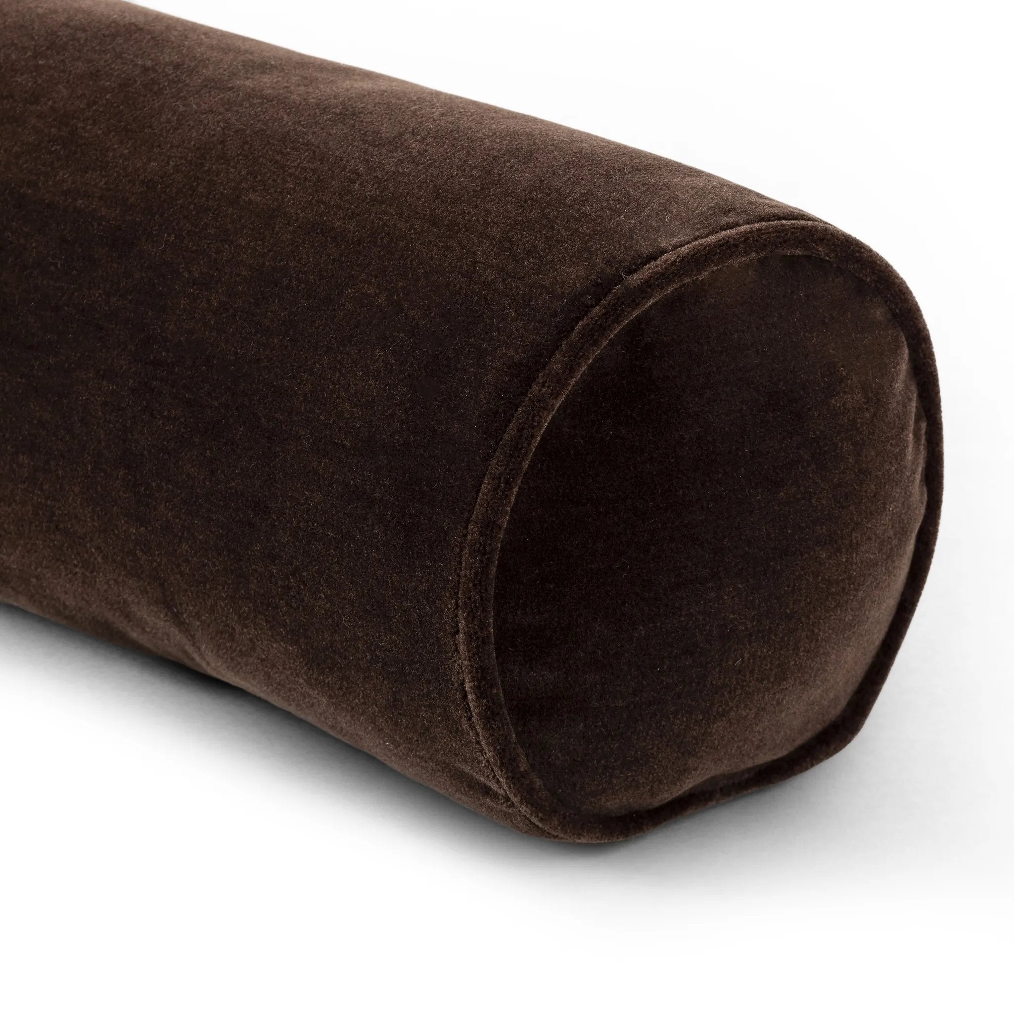 A long, chocolate-colored bolster pillow elevates beds and sofas in an instant. Crafted from saturated wool velvet, for a sustainable alternative to mohair, with a hidden zipper for a smooth silhouette Amethyst Home provides interior design, new home construction design consulting, vintage area rugs, and lighting in the Calabasas metro area.
