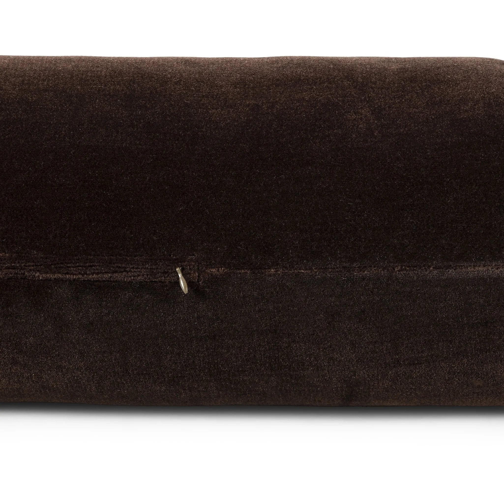 A long, chocolate-colored bolster pillow elevates beds and sofas in an instant. Crafted from saturated wool velvet, for a sustainable alternative to mohair, with a hidden zipper for a smooth silhouette Amethyst Home provides interior design, new home construction design consulting, vintage area rugs, and lighting in the Monterey metro area.