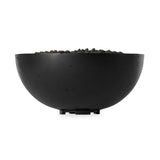 This outdoor fire table is a welcoming centerpiece designed for gathering. Made from glass-reinforced concrete, each piece is naturally finished with deep tones of charcoal. The bowl shape is completed with lavastones in the center, bringing together a bold, monochromatic look. Professional installation required to connect to a natural gas line. Amethyst Home provides interior design, new home construction design consulting, vintage area rugs, and lighting in the Salt Lake City metro area.