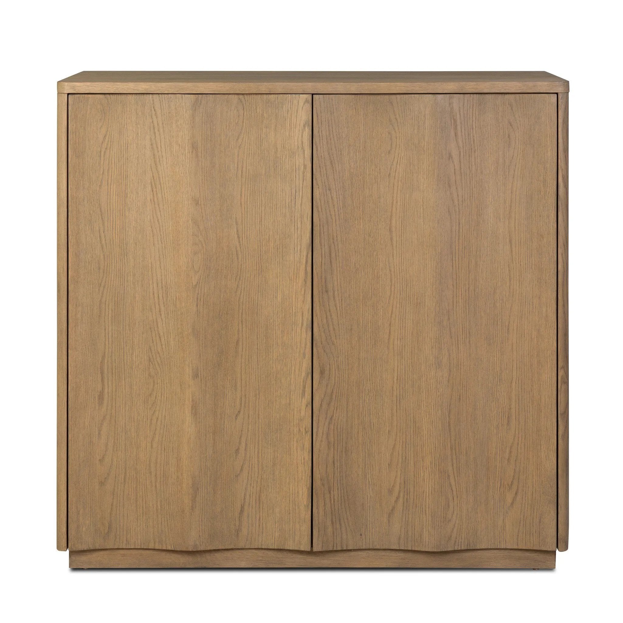 The classic wooden cabinet, reimagined. This warm oak piece features double doors with shallow scalloping that draws the eye, providing a subtle visual flow.As lovers of wabi sabi design at Amethyst, we love the designer inspired Brookhurst Small Cabinet - Drifted Oak Veneer. Amethyst Home provides interior design, new home construction design consulting, vintage area rugs, and lighting in the Salt Lake City metro area.