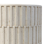 Cast concrete shapes a drum-style outdoor end table, with a linear pattern layered for added texture. Finished with a parchment-like textural feel. Cover or store inside during inclement weather and when not in use.As enthusiasts of luxe style at Amethyst, we love the optimistic inspired Callisto Outdoor End Table - Aged White Concrete. Amethyst Home provides interior design, new home construction design consulting, vintage area rugs, and lighting in the Los Angeles metro area.