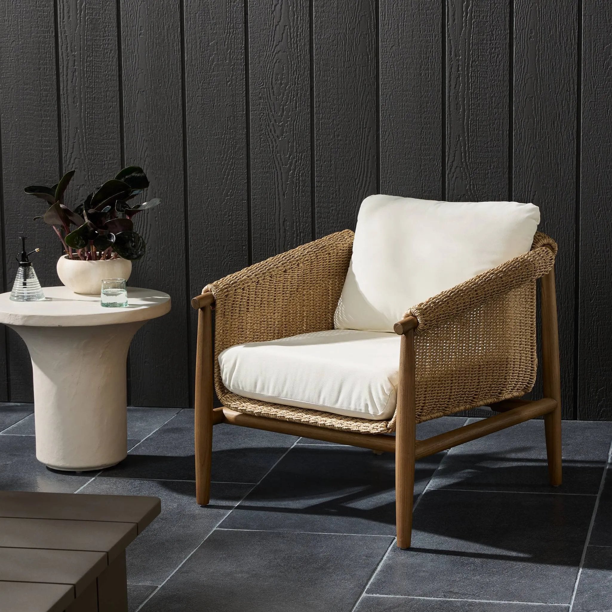 Bring home vintage inspiration. The sling shape of this outdoor chair features a reimagined bucket seat in woven faux hyacinth, finished with rounded tapered legs that mirror the shape of the frame. Cover or store indoors during inclement weather and when not in use Amethyst Home provides interior design, new home construction design consulting, vintage area rugs, and lighting in the Houston metro area.