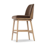 Solid ash wood forms a subtly curved back on this everyday counter stool. Its open frame and seat features rounded edges for 