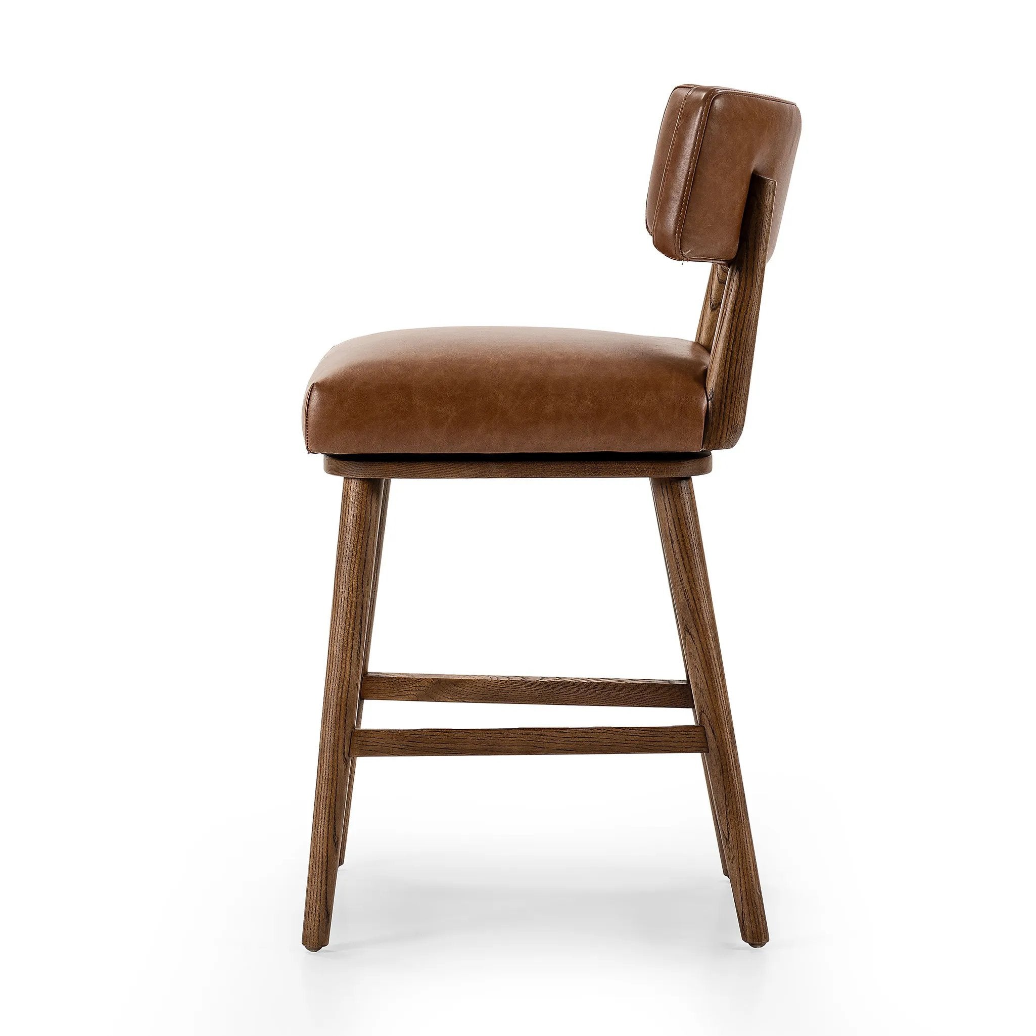 Featuring Cardell Sonoma Chestnut Swivel Bar + Counter Stool by Four Hands at Amethyst Home. This reimagined classic pairs a barrel back frame of solid nettlewood with top-grain leather in a rich chestnut. A 180-degree swivel with return memory tops off the piece with fresh functionality.BarOverall Dimensions: 21.50"w x 22.25"d x 42.50"hWeight: 24.25 lbsCount. Amethyst Home provides interior design, new home construction design consulting, vintage area rugs, and lighting in the Houston metro area.