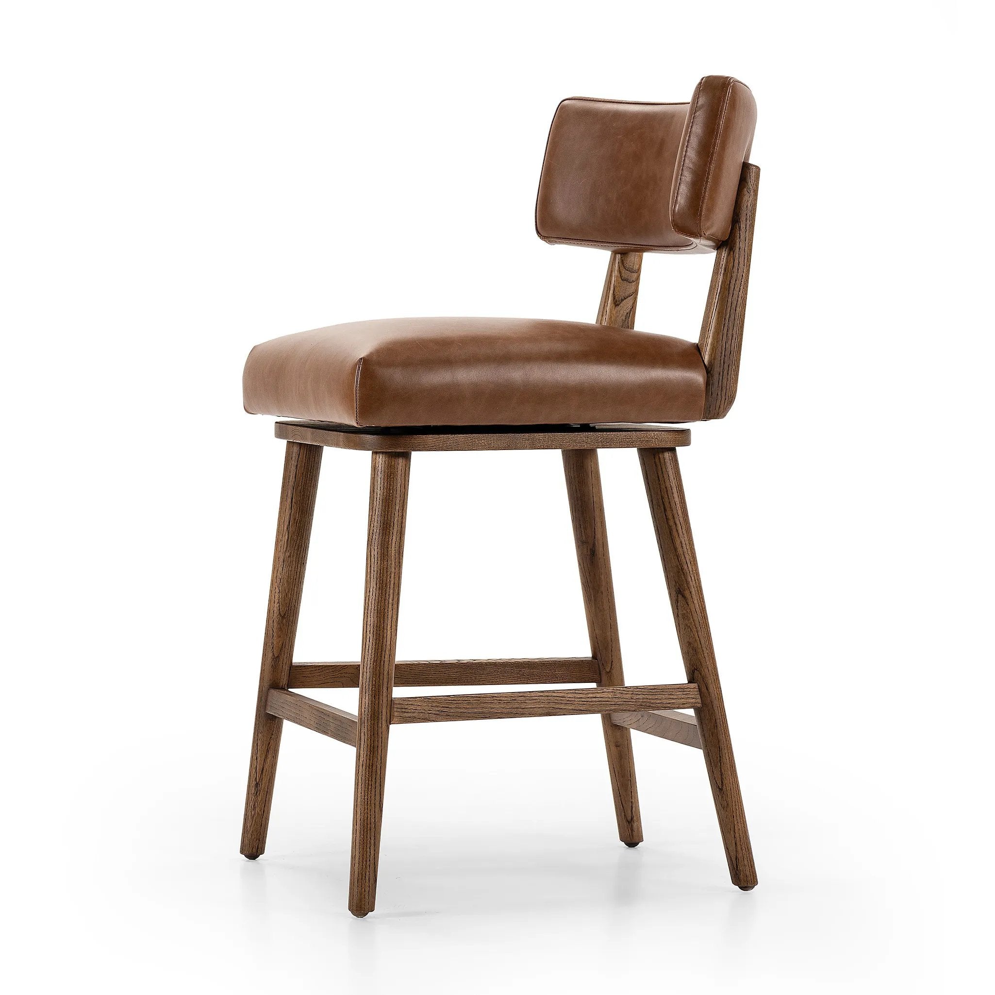 Featuring Cardell Sonoma Chestnut Swivel Bar + Counter Stool by Four Hands at Amethyst Home. This reimagined classic pairs a barrel back frame of solid nettlewood with top-grain leather in a rich chestnut. A 180-degree swivel with return memory tops off the piece with fresh functionality.BarOverall Dimensions: 21.50"w x 22.25"d x 42.50"hWeight: 24.25 lbsCou. Amethyst Home provides interior design, new home construction design consulting, vintage area rugs, and lighting in the Park City metro area.