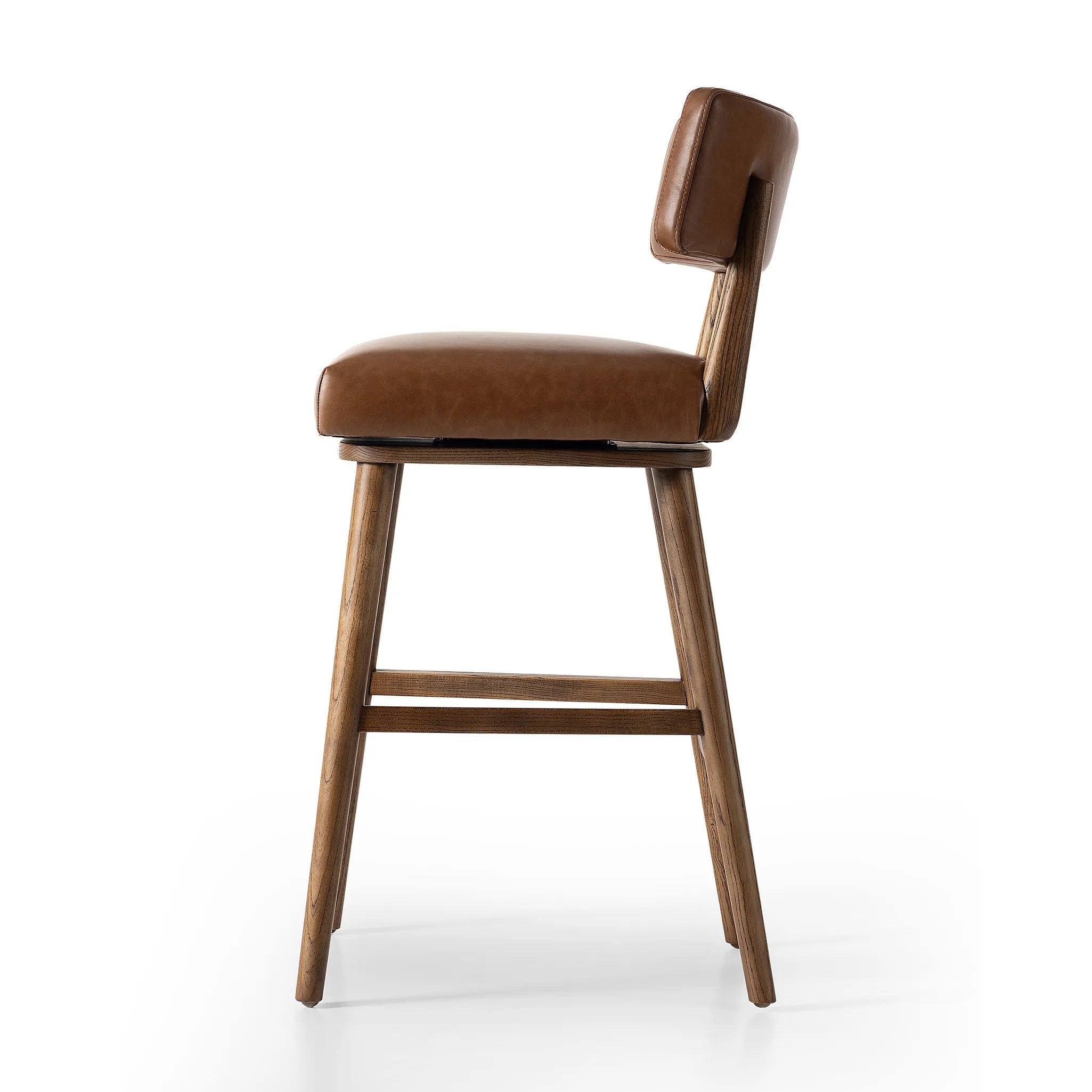 Featuring Cardell Sonoma Chestnut Swivel Bar + Counter Stool by Four Hands at Amethyst Home. This reimagined classic pairs a barrel back frame of solid nettlewood with top-grain leather in a rich chestnut. A 180-degree swivel with return memory tops off the piece with fresh functionality.BarOverall Dimensions: 21.50"w x 22.25"d x 42.50"hWeight: 24.25 lbsCounter. Amethyst Home provides interior design, new home construction design consulting, vintage area rugs, and lighting in the Tampa metro area.