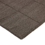 Hand woven in a flat weave grid pattern for the look of an indoor textile, this  mineral-hued rug grounds the outdoor lounge with a high-texture look. Slight variation in sizing and imperfect lines due to the handcrafted nature of each piece are to be expected. Store inside during inclement weather and when not in use. Amethyst Home provides interior design, new home construction design consulting, vintage area rugs, and lighting in the Alpharetta metro area.