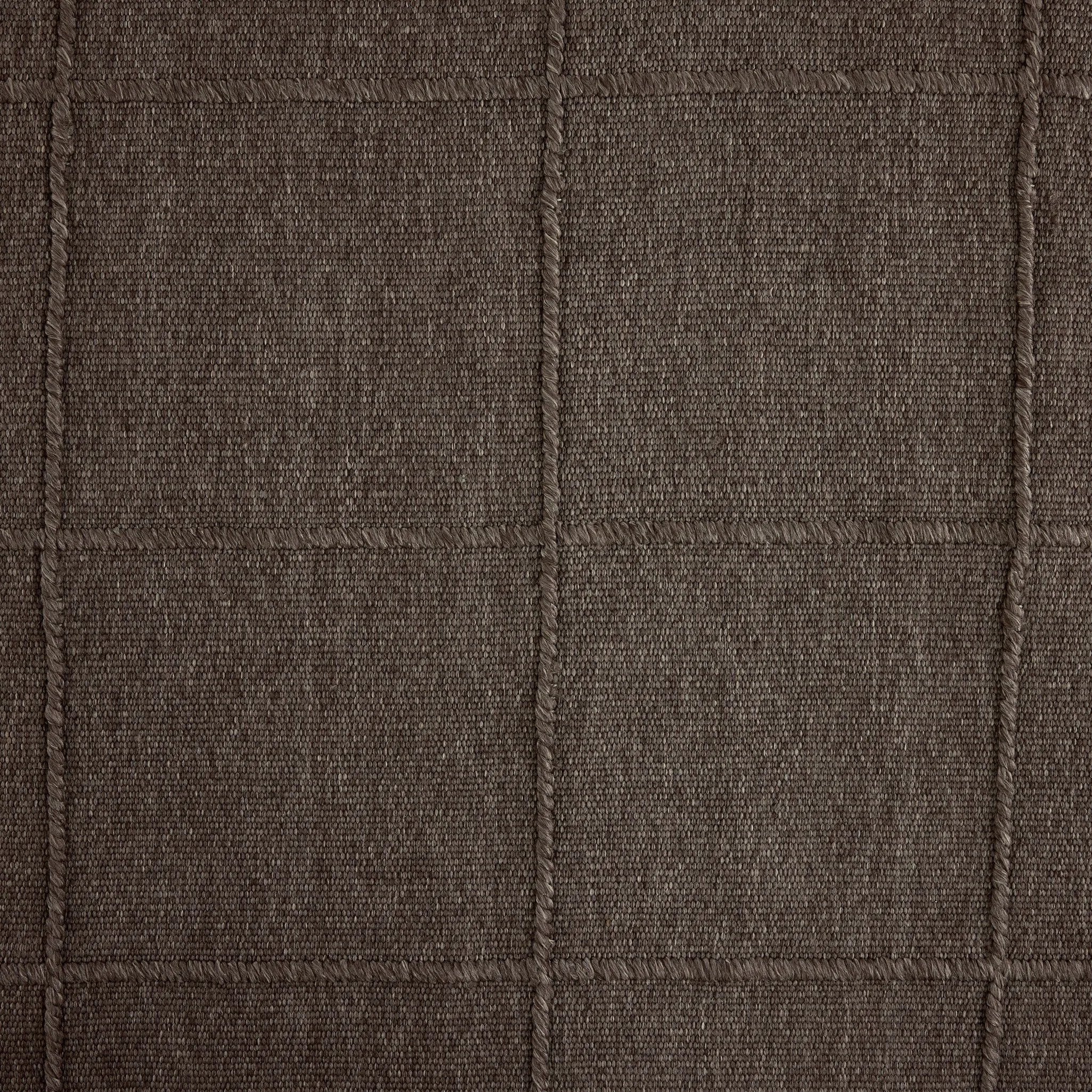 Hand woven in a flat weave grid pattern for the look of an indoor textile, this  mineral-hued rug grounds the outdoor lounge with a high-texture look. Slight variation in sizing and imperfect lines due to the handcrafted nature of each piece are to be expected. Store inside during inclement weather and when not in use. Amethyst Home provides interior design, new home construction design consulting, vintage area rugs, and lighting in the Boston metro area.