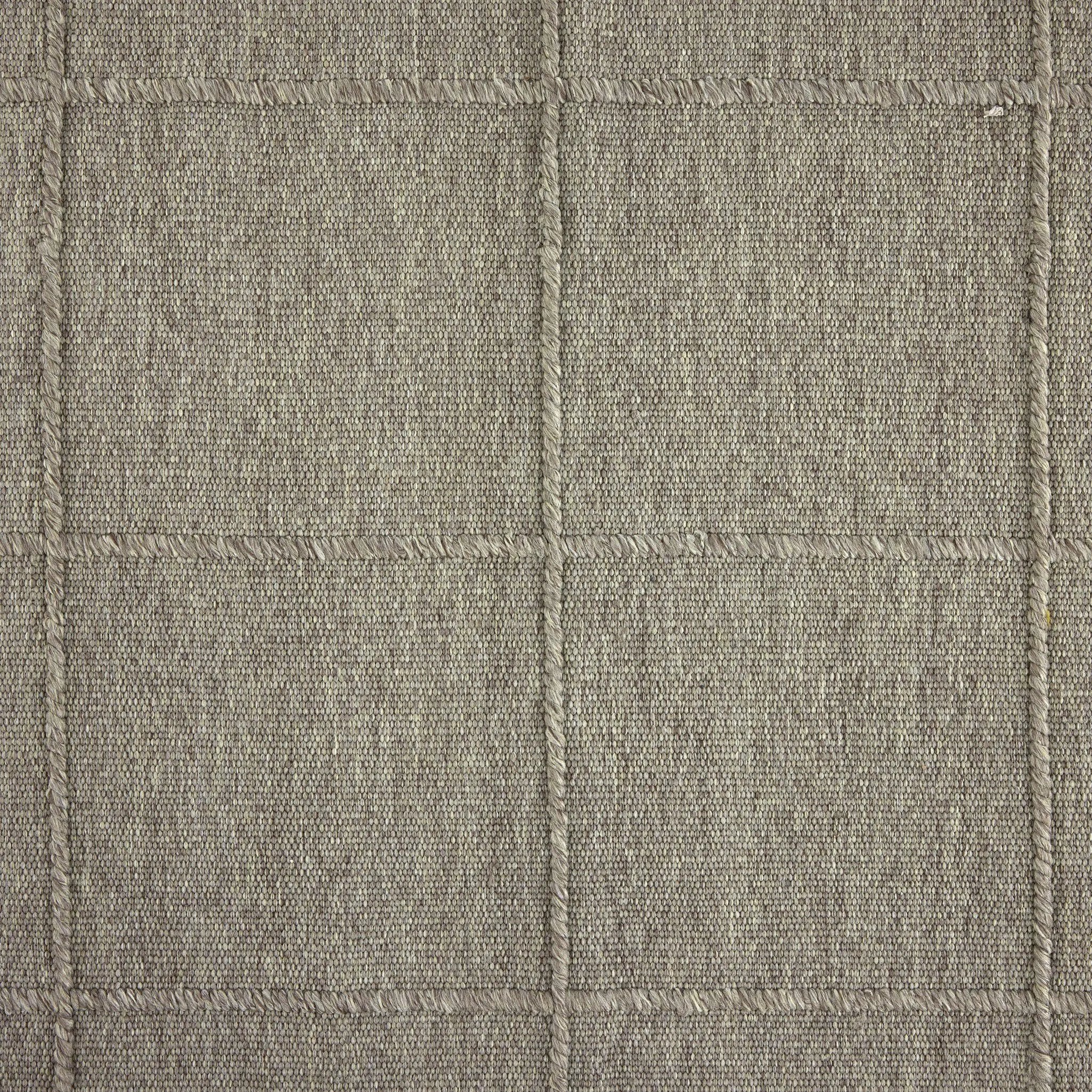 Hand woven in a flat weave grid pattern for the look of an indoor textile, this  silver-hued rug grounds the outdoor lounge with a high-texture look. Slight variation in sizing and imperfect lines due to the handcrafted nature of each piece are to be expected. Store inside during inclement weather and when not in use. Amethyst Home provides interior design, new home construction design consulting, vintage area rugs, and lighting in the Des Moines metro area.