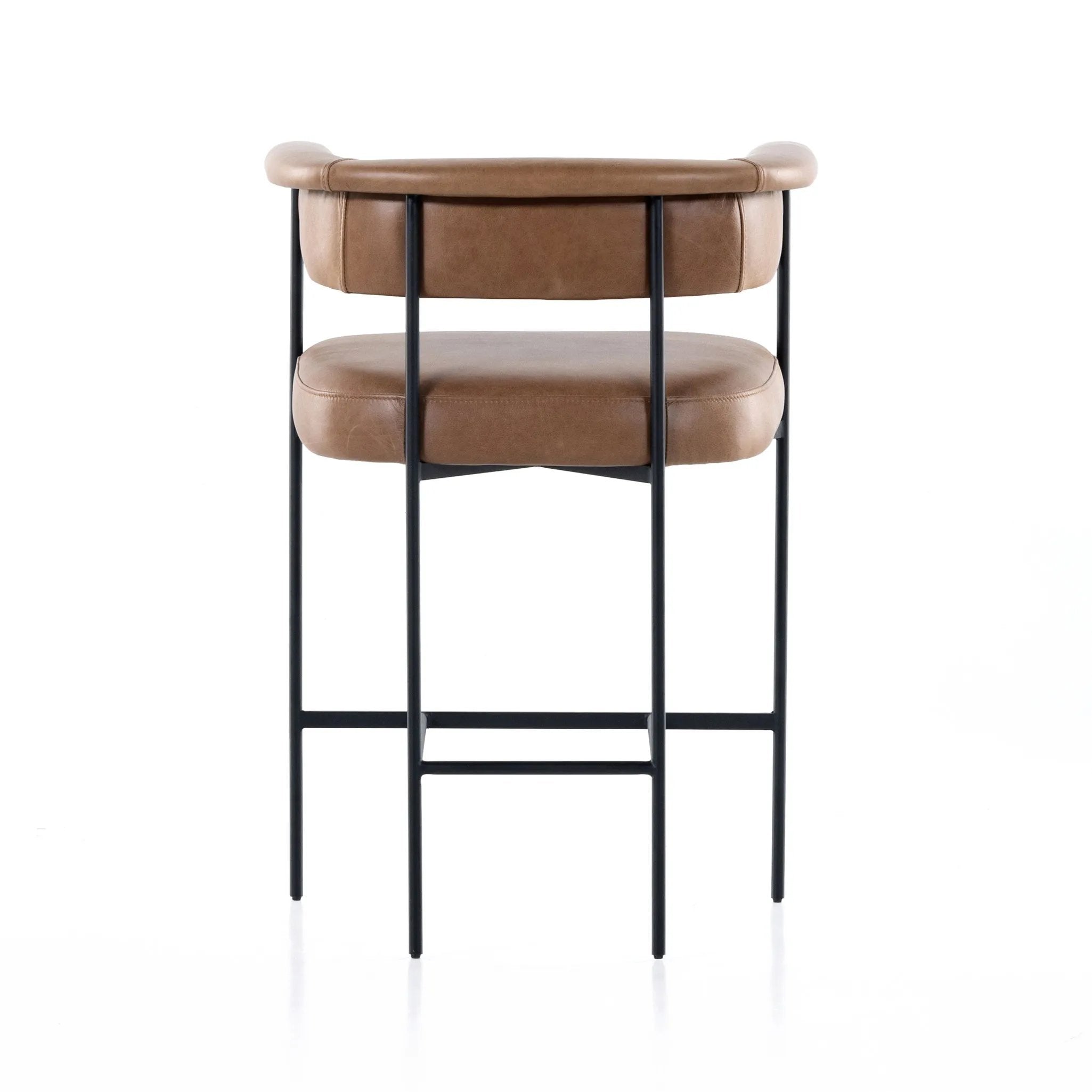 Featuring Carrie Chaps Saddle Bar + Counter Stool by Four Hands at Amethyst Home. Airy and light with slim, matte black-finished iron framing, tan top-grain leather lends sleekness to a beautifully sculpted counter style featuring a yoke back and exterior fold detailing.BarOverall Dimensions: 25.50"w x 23.00"d x 39.50"hWeight: 33.95 lbsCounterOverall Dim. Amethyst Home provides interior design, new home construction design consulting, vintage area rugs, and lighting in the Laguna Beach metro area.