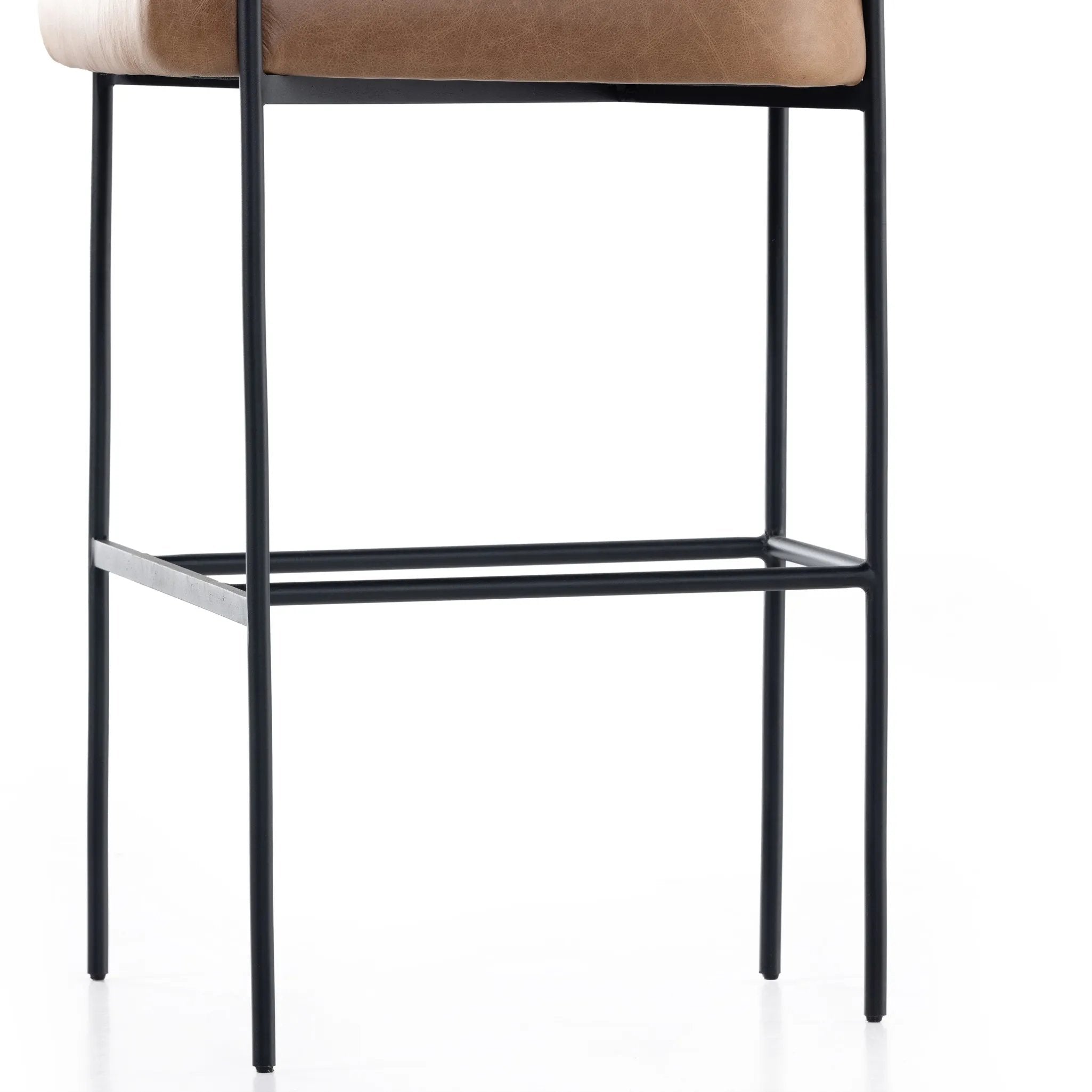 Featuring Carrie Chaps Saddle Bar + Counter Stool by Four Hands at Amethyst Home. Airy and light with slim, matte black-finished iron framing, tan top-grain leather lends sleekness to a beautifully sculpted counter style featuring a yoke back and exterior fold detailing.BarOverall Dimensions: 25.50"w x 23.00"d x 39.50"hWeight: 33.95 lbsCounterOverall Dimensi. Amethyst Home provides interior design, new home construction design consulting, vintage area rugs, and lighting in the Portland metro area.