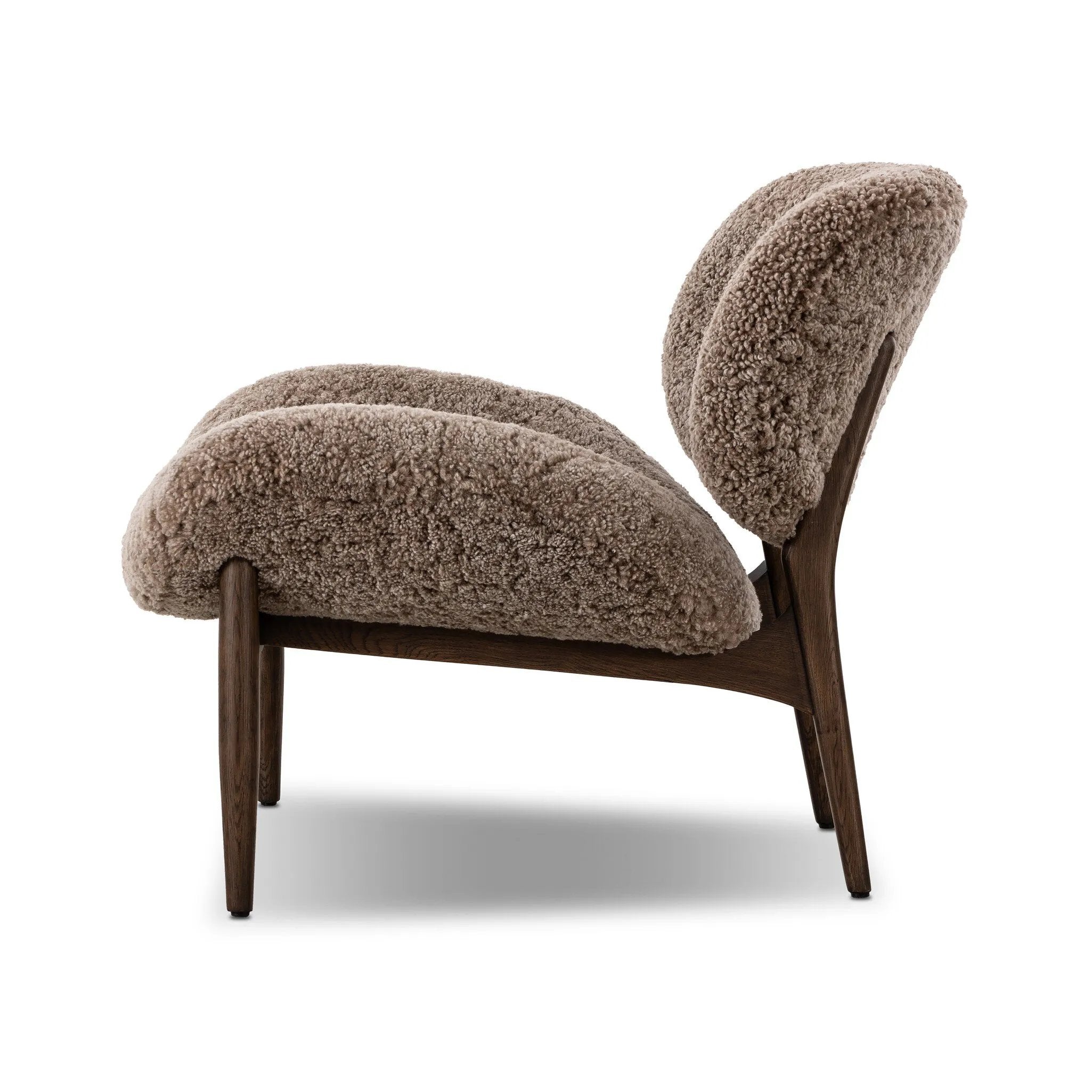 The perfect accent chair, designed for unwinding. Upholstered in a velvety olive chenille made from recycled materials, with wide proportions and cozy curves and cushioning. Slim, tapered wooden legs balance the look Amethyst Home provides interior design, new home construction design consulting, vintage area rugs, and lighting in the Boston metro area.