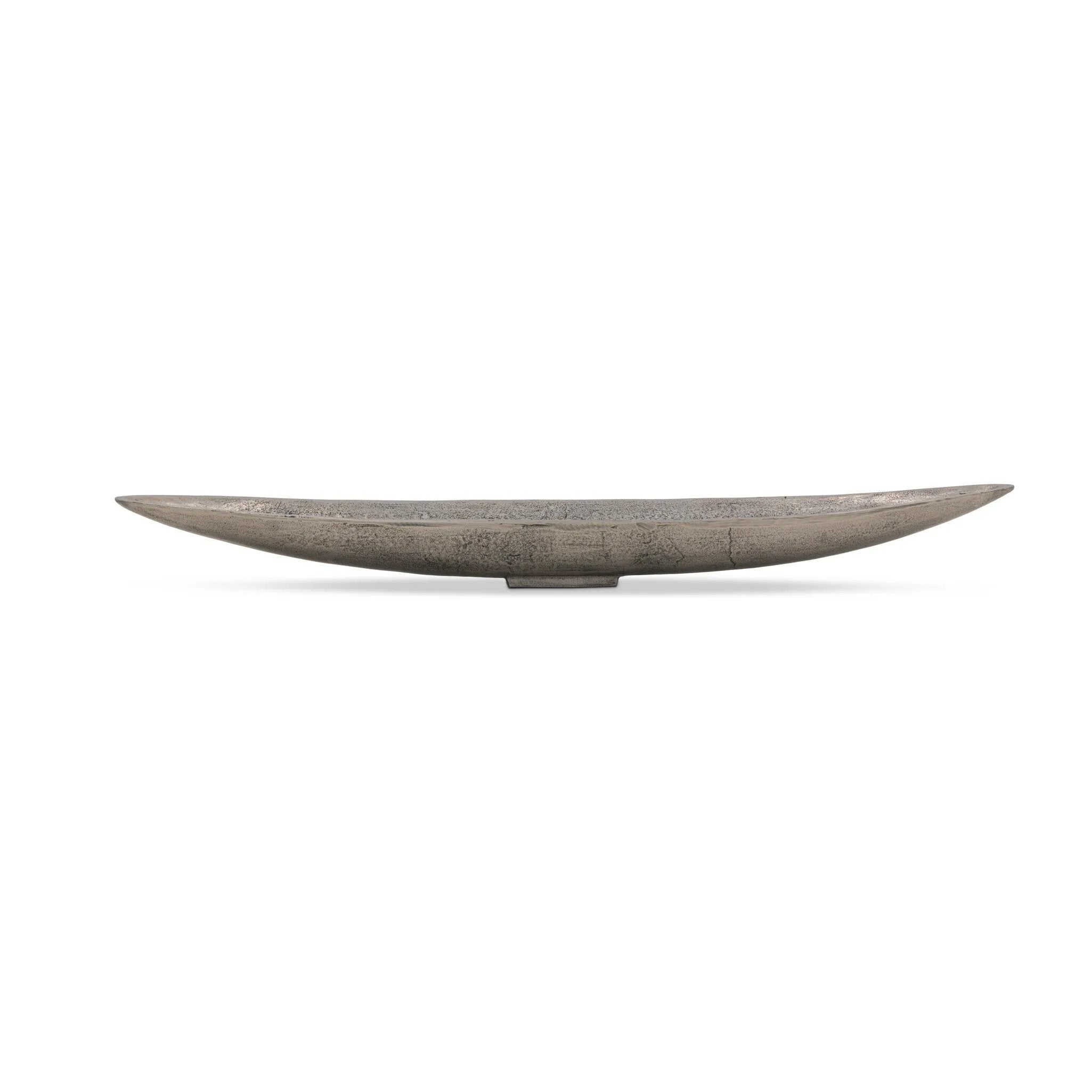 Statement-making centerpiece bowl featuring dramatic swooping lines, taking inspiration from Japanese fishing canoes. Cast in solid aluminum and supported by a single pedestal foot, giving the illusion that it's truly floating off the table.As lovers of clean design at Amethyst, we love the designer inspired Cerys Bowl - Raw Antique Nickel. Amethyst Home provides interior design, new home construction design consulting, vintage area rugs, and lighting in the Kansas City metro area.
