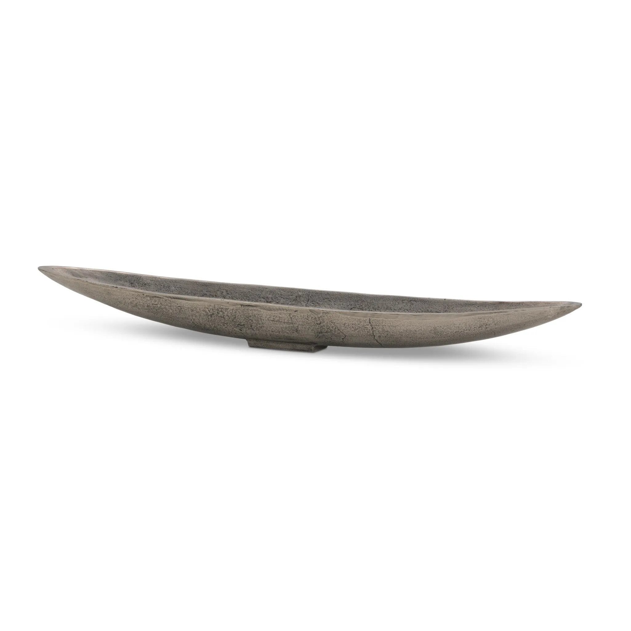 Statement-making centerpiece bowl featuring dramatic swooping lines, taking inspiration from Japanese fishing canoes. Cast in solid aluminum and supported by a single pedestal foot, giving the illusion that it's truly floating off the table.As lovers of clean design at Amethyst, we love the designer inspired Cerys Bowl - Raw Antique Nickel. Amethyst Home provides interior design, new home construction design consulting, vintage area rugs, and lighting in the Nashville metro area.