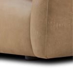Meet modern comfort. Clean curves, impeccable tailoring and taupe top-grain leather with a pronounced grain bring an elevated, European-inspired look to this sofa Amethyst Home provides interior design, new home construction design consulting, vintage area rugs, and lighting in the Austin metro area.