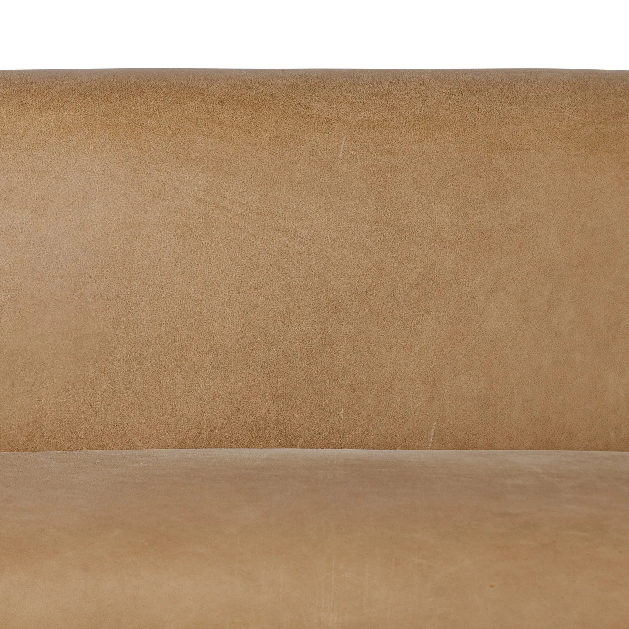 Meet modern comfort. Clean curves, impeccable tailoring and taupe top-grain leather with a pronounced grain bring an elevated, European-inspired look to this sofa Amethyst Home provides interior design, new home construction design consulting, vintage area rugs, and lighting in the Charlotte metro area.