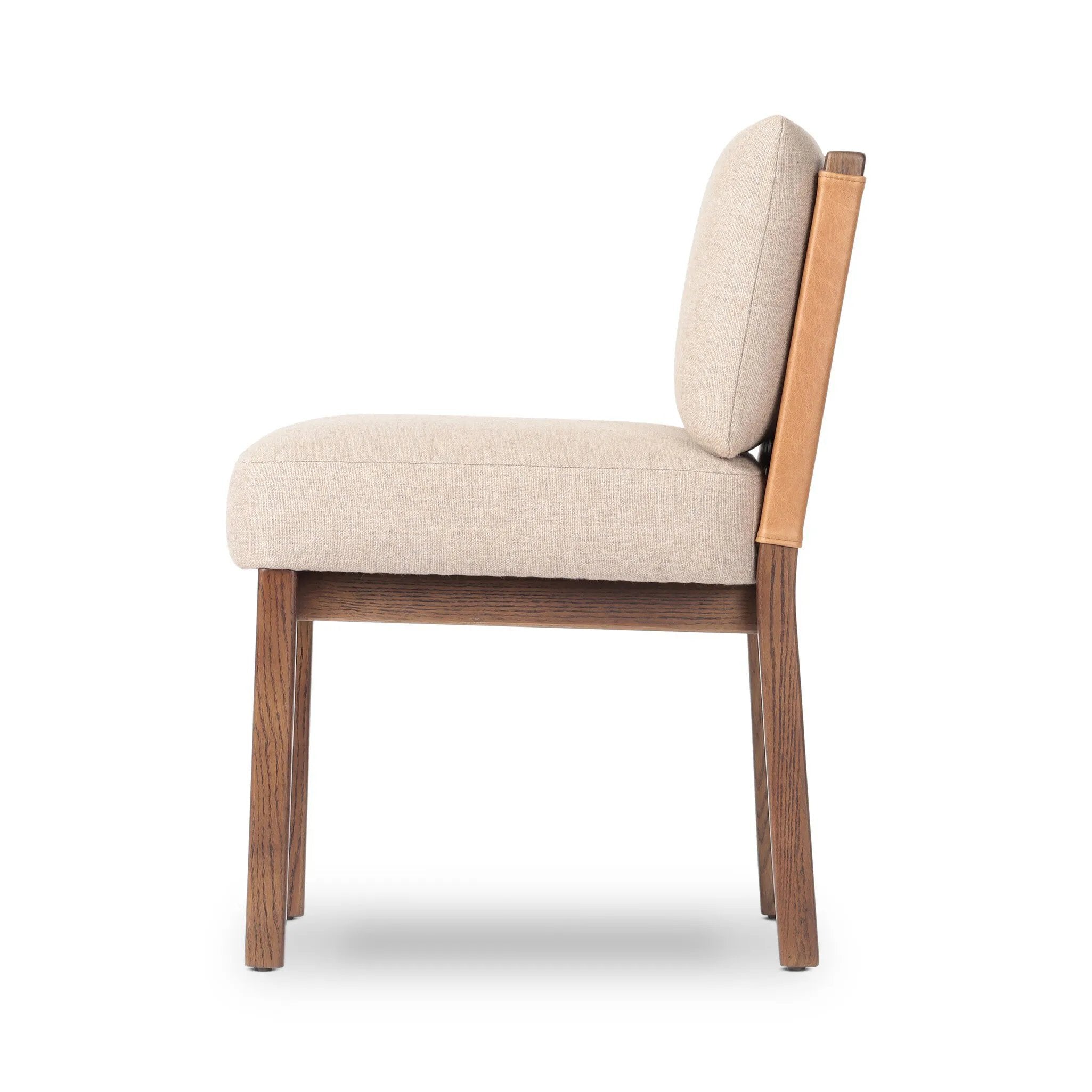 Elevate your dining space with a mixed-material dining chair of solid oak, top-grain leather and high-performance fabric. On the back, small iron detailing completes the look Amethyst Home provides interior design, new home construction design consulting, vintage area rugs, and lighting in the Newport Beach metro area.