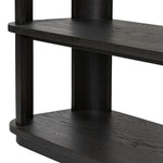 Unexpected contours give this bookcase its warm, modern vibe. Crafted oak veneer with a worn black finish, rounded legs are inset from the shelves with a plinth-like effect Amethyst Home provides interior design, new home construction design consulting, vintage area rugs, and lighting in the Omaha metro area.