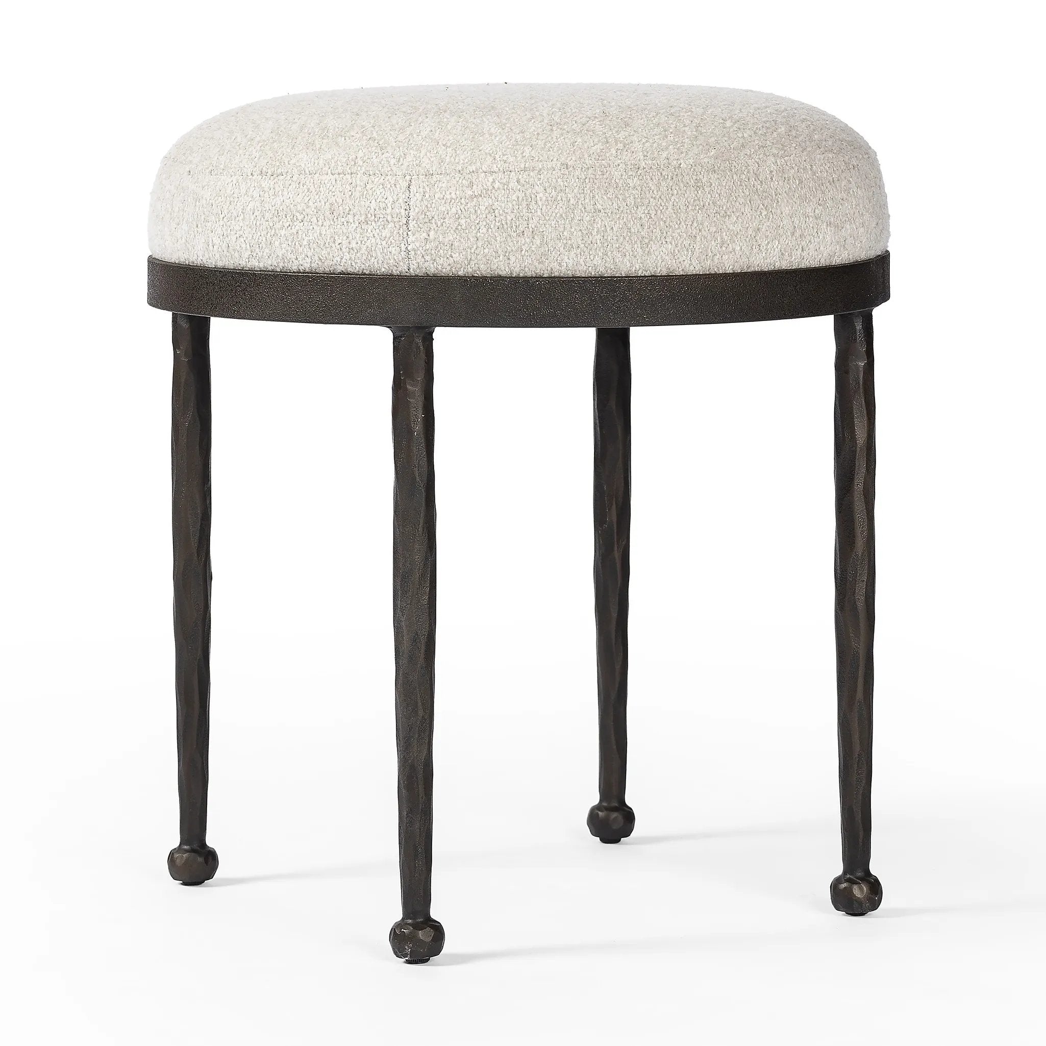 Work midcentury vibes into any space with a pared-back accent stool that doubles as a cocktail ottoman. Wrough iron legs finished in a hammered bronze pair with a simple rounded seat upholstered in a texture-rich fabric, with S-spring suspension for comfort and structure Amethyst Home provides interior design, new home construction design consulting, vintage area rugs, and lighting in the Winter Garden metro area.