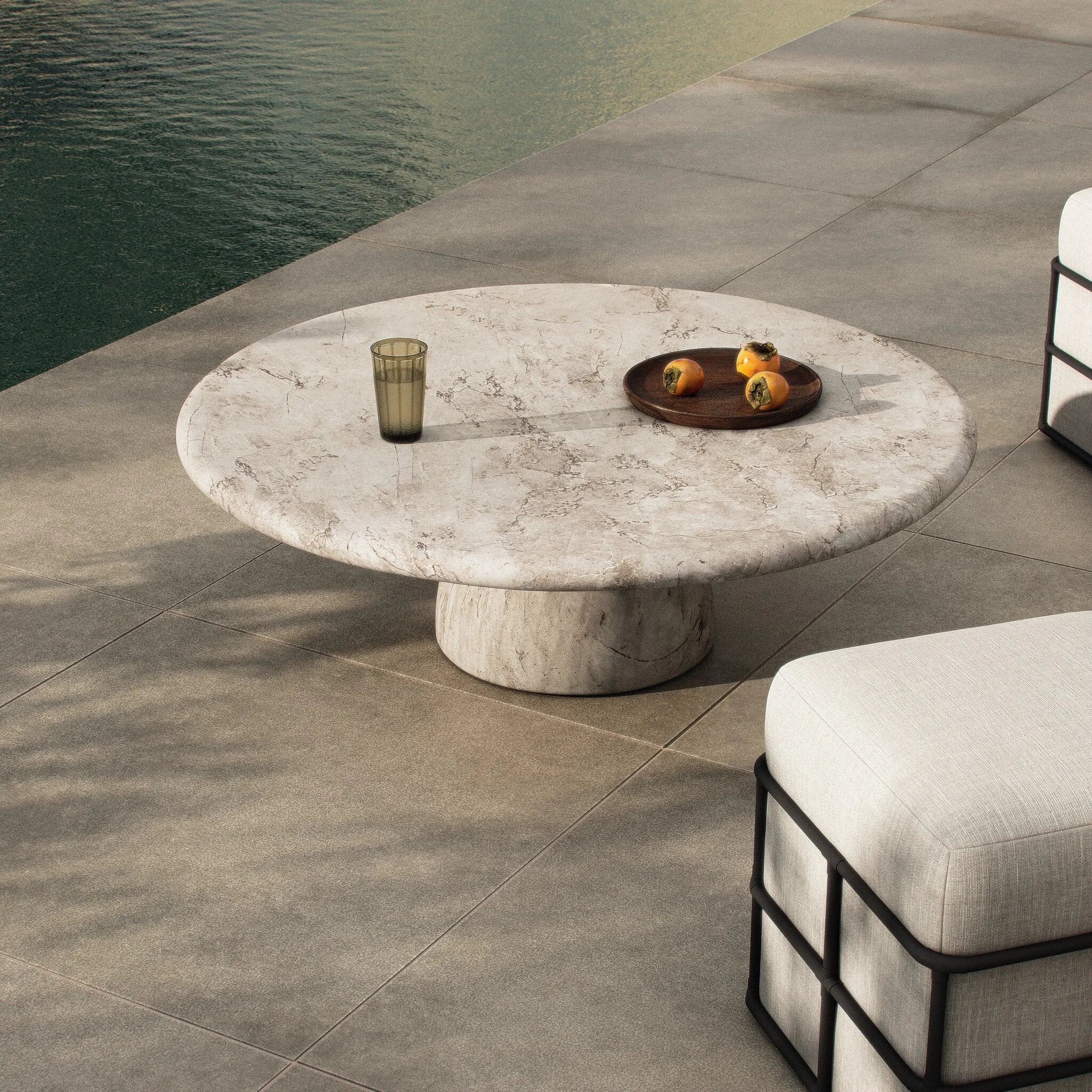 Soft curves define this classic pedestal-style outdoor coffee table. Cast concrete is finished with a natural water transfer finish meant to mimic natural veined marble. Cover or store inside during inclement weather and when not in use. Amethyst Home provides interior design, new home construction design consulting, vintage area rugs, and lighting in the Alpharetta metro area.