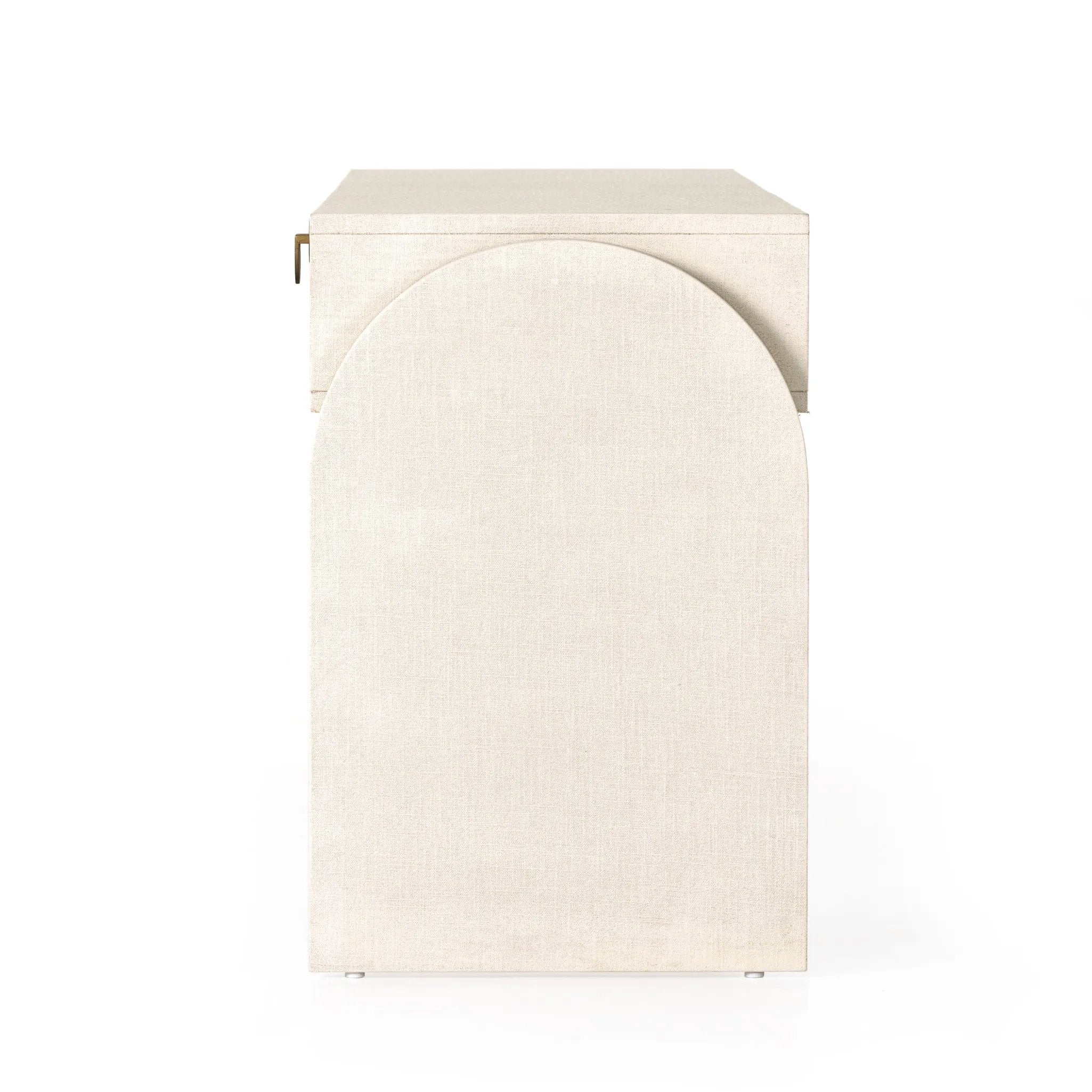Talk about novelty. Made from painted linen in a light ivory, arched legs soften otherwise clean, modern shaping. Three drawers bring bonus storage space to the living or media room, while half-moon iron hardware adds a hint of art deco style Amethyst Home provides interior design, new home construction design consulting, vintage area rugs, and lighting in the Houston metro area.