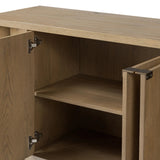 Featuring Cristopher Rubbed Light Oak Veneer Sideboard by Four Hands at Amethyst Home. A playful placement of rounded shapes and clean lines, this sideboard captivates with half-cylinder legs seamlessly blending into the storage case and top, complete with curved metal hardware. Finished in light oak for warm, light look that can move between styles with . Amethyst Home provides interior design, new home construction design consulting, vintage area rugs, and lighting in the Los Angeles metro area.
