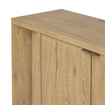 Featuring Cristopher Rubbed Light Oak Veneer Sideboard by Four Hands at Amethyst Home. A playful placement of rounded shapes and clean lines, this sideboard captivates with half-cylinder legs seamlessly blending into the storage case and top, complete with curved metal hardware. Finished in light oak for warm, light look that can move between styles with ea. Amethyst Home provides interior design, new home construction design consulting, vintage area rugs, and lighting in the Nashville metro area.