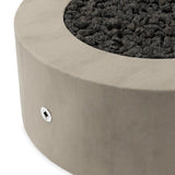 This outdoor fire table is a welcoming centerpiece designed for gathering. Made from glass-reinforced concrete, each piece is naturally finished with deep tones of pewter and dark grey. The monolithic shape is completed with lavastones in the center, bringing together a bold, monochromatic look. Amethyst Home provides interior design, new home construction design consulting, vintage area rugs, and lighting in the Charlotte metro area.