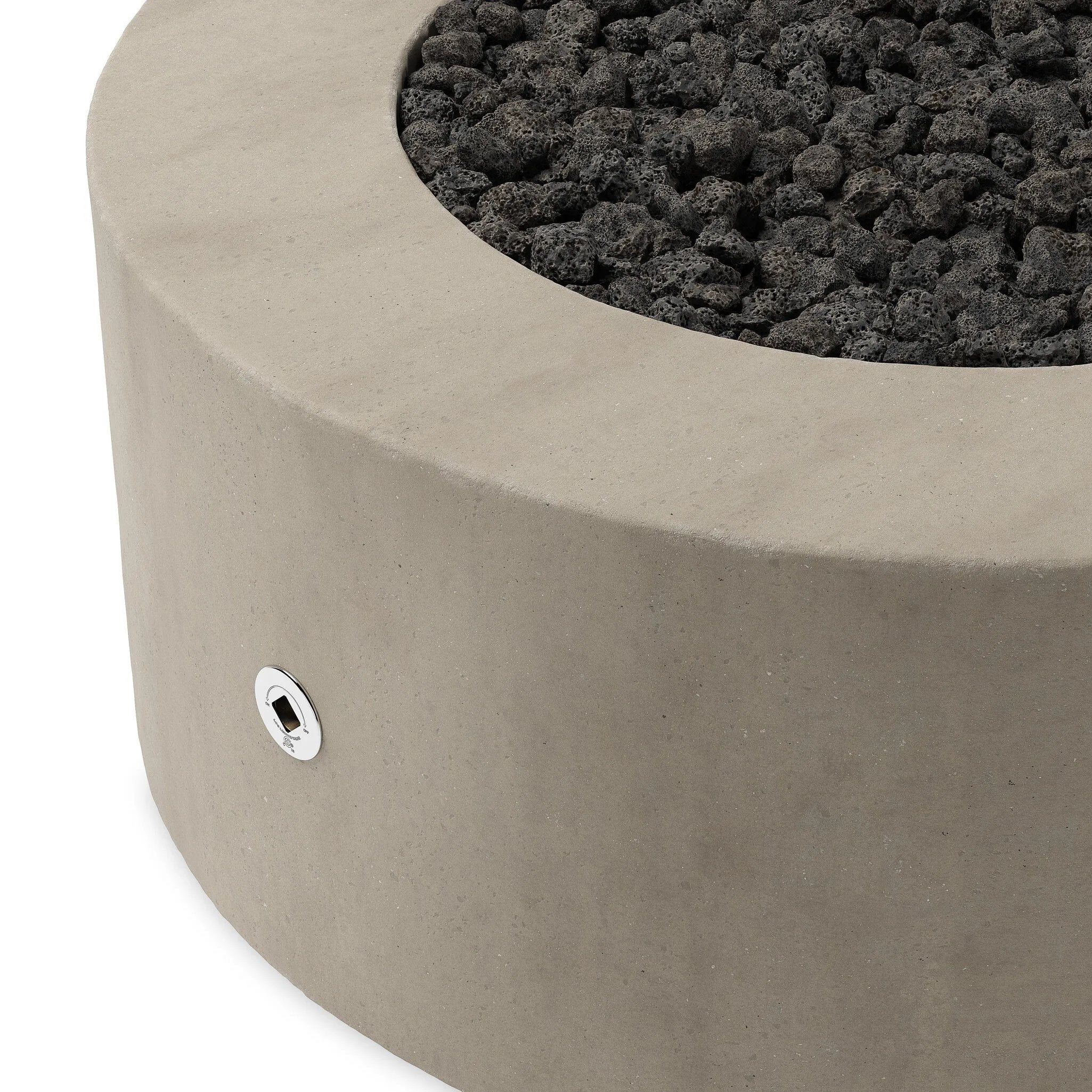 This outdoor fire table is a welcoming centerpiece designed for gathering. Made from glass-reinforced concrete, each piece is naturally finished with deep tones of pewter and dark grey. The monolithic shape is completed with lavastones in the center, bringing together a bold, monochromatic look. Amethyst Home provides interior design, new home construction design consulting, vintage area rugs, and lighting in the Charlotte metro area.