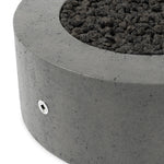 This outdoor fire table is a welcoming centerpiece designed for gathering. Made from glass-reinforced concrete, each piece is naturally finished with deep tones of pewter and dark grey. The monolithic shape is completed with lavastones in the center, bringing together a bold, monochromatic look. Amethyst Home provides interior design, new home construction design consulting, vintage area rugs, and lighting in the Washington metro area.